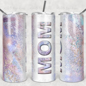 May include: A white stainless steel tumbler with a purple, pink, and blue glitter design. The word "MOM" is printed in large, white letters on the tumbler.