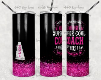 May include: A black and pink tumbler with glitter and a white megaphone with the number 2021 on it. The tumbler has the text "I never dreamed I would be a super cool coach but here I am rocking it!"