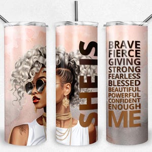 May include: A set of three stainless steel insulated tumblers with a portrait of a woman with gray curly hair, sunglasses, and gold jewelry. The tumblers have the words "SHE IS" and "BRAVE, FIERCE, GIVING, STRONG, FEARLESS, BLESSED, BEAUTIFUL, POWERFUL, CONFIDENT, ENOUGH, ME."
