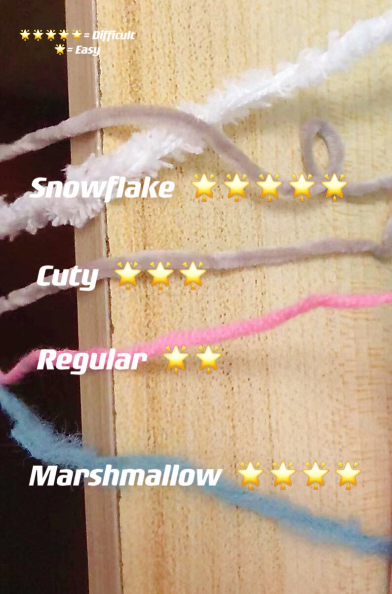 May include: Four different types of yarn are shown on a wooden surface. The yarn types are labeled "Snowflake", "Cuty", "Regular", and "Marshmallow". Each yarn type is rated with a star rating system, with five stars being the most difficult and one star being the easiest. Snowflake is rated five stars, Cuty is rated three stars, Regular is rated two stars, and Marshmallow is rated four stars.