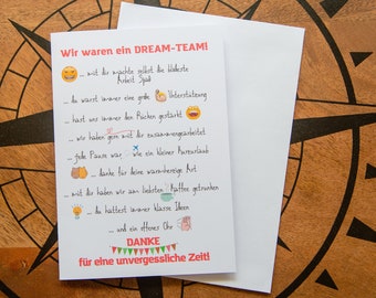 May include: A white greeting card with German text and colorful illustrations, including a smiling face, a coffee cup, and a lightbulb. The card is on a wooden surface with a compass design.