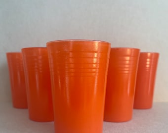 May include: Set of six orange glass tumblers with a white rim. The tumblers have a ribbed design and are perfect for everyday use.