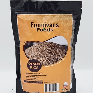 May include: A brown bag of Ofada Rice packaged by Emmivansfoods. The bag has a label with the company name, product name, address, phone number, website, and a health choice for your home message. The bag is on a white background.