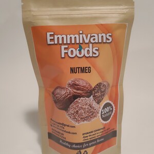 May include: A brown paper bag with a zipper closure, containing whole nutmeg and ground nutmeg. The bag has a label with the text "Emmivans Foods" and "Nutmeg" in a white font on an orange background. The label also includes the text "100% Natural" in a white circle with a green leaf on a red background. The label also includes the text "Healthy choice for your home" in a white font on an orange background.