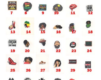 May include: A set of 36 colorful shoe charms featuring various designs related to Black culture, including Black Lives Matter, I Love My HBCU, and Black Power. The charms are made of plastic and have a variety of shapes and sizes.