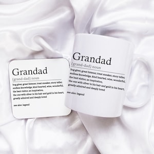 May include: White ceramic mug and coaster with the word "Grandad" defined as "hug giver, great listener, treat sneaker, story teller, endless knowledge, kind hearted, wise, wonderful, the best visitor, an inspiration, the one with silver in his hair and gold in his heart, greatly admired and deeply loved. See also: legend."
