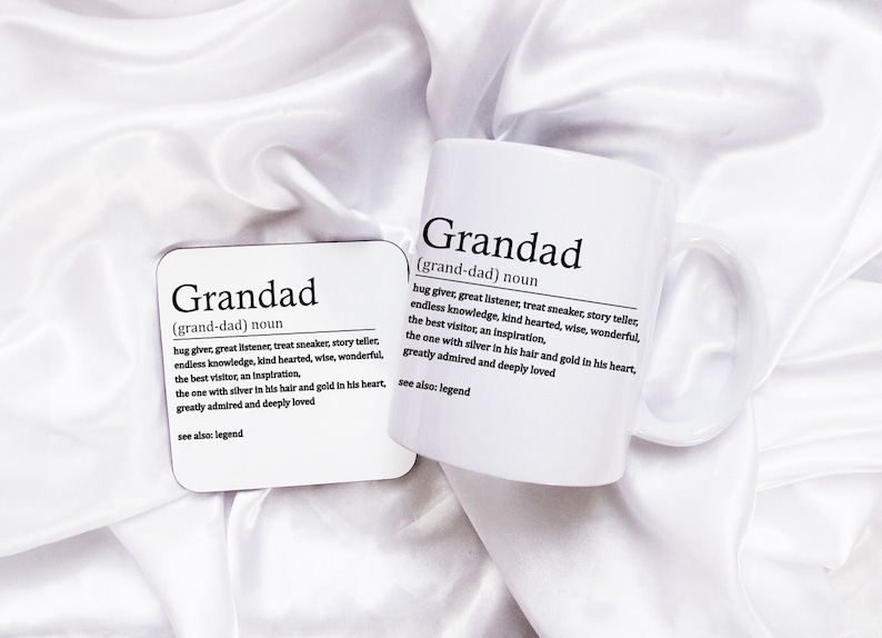 May include: White ceramic mug and coaster with the word "Grandad" defined as "hug giver, great listener, treat sneaker, story teller, endless knowledge, kind hearted, wise, wonderful, the best visitor, an inspiration, the one with silver in his hair and gold in his heart, greatly admired and deeply loved. See also: legend."