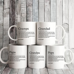 May include: Five white ceramic mugs with black text. Each mug has a different word on it: Gramps, Grandad, Papa, Grandpa, and Pops. The words are defined as a noun and the definition is written in black text below the word.