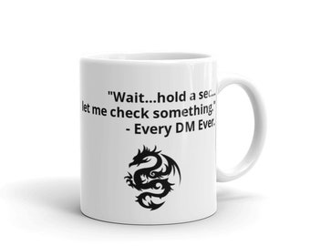 May include: White ceramic mug with a black dragon design and the text "Wait...hold a sec...let me check something... - Every DM Ever."