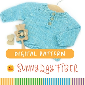May include: A light blue knitted baby sweater with a button closure. The sweater is laid flat on a white background with a wooden toy nearby. The text "DIGITAL PATTERN" and "SUNNY DAY FIBER" is displayed below the sweater.