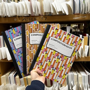 May include: Three composition books with black spines and rectangular labels reading COMPOSITION BOOK, WIDE RULED, 100 sheets - 200 pages, 9.75 in x 7.5 in / 24.7 cm x 19 cm. Each cover features a colorful, geometric brick-like pattern in varying hues.