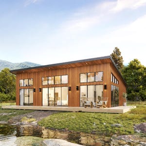 May include: A single-storey modern house with vertical wood cladding and a slanted roof. The exterior features large floor-to-ceiling glass windows and sliding doors, a wooden deck, and black wall-mounted light fixtures, set in a natural landscape.