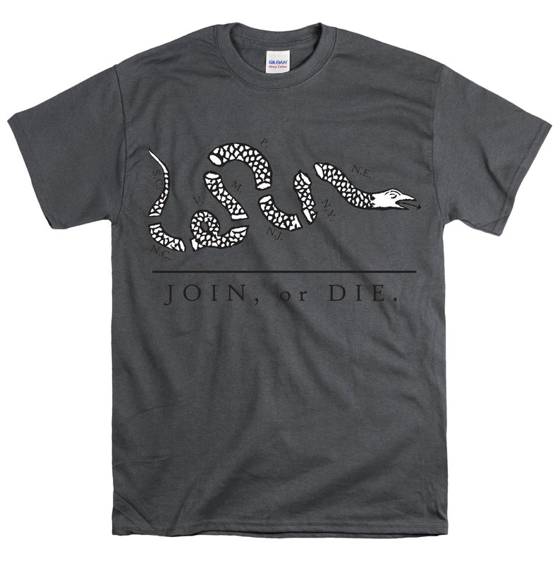 May include: A dark gray t-shirt with a white image of a snake with the words "JOIN, or DIE." printed on the front. The snake is divided into sections, each labeled with the initials of a state:  "N.E.", "N.Y.", "N.J.", "P.", "M.", "V.", "N.C.", "S.C."
