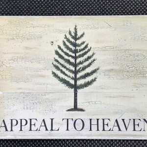 May include: A vintage-style wooden sign with a green pine tree and the text "APPEAL TO HEAVEN". The sign has a distressed, weathered look with a white background.