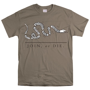 May include: A brown t-shirt with a black and white image of a snake with the words "JOIN, or DIE." and the abbreviations of the original 13 colonies.