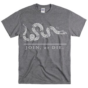 May include: A gray t-shirt with a white print of a snake with the words "JOIN, or DIE." and abbreviations for the original 13 colonies.