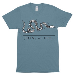 May include: A light blue t-shirt with a black and white image of a snake with the words "JOIN, or DIE." and the abbreviations of states on the snake.