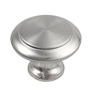 May include: A silver round cabinet knob with a raised edge and a smooth, shiny finish.