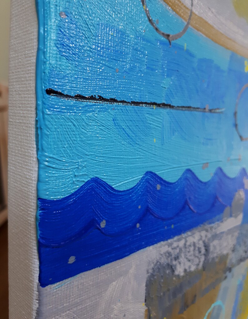 May include: Abstract painting featuring blue, turquoise, and white paint. The paint is applied in thick strokes, creating a textured surface. The painting is framed and ready to hang.