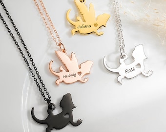 May include: Three silver necklaces with a lizard silhouette pendant. Each pendant has a different name engraved on it: Juliana, Hedwig, and Rose.