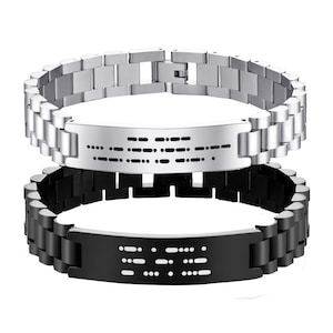 May include: Two stainless steel bracelets with Morse code detailing. One bracelet is silver, the other is black. Both have a chain link design and a rectangular plate with the Morse code pattern.
