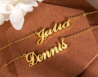 May include: Two gold necklaces with the names "Julia" and "Dennis" written in cursive script.