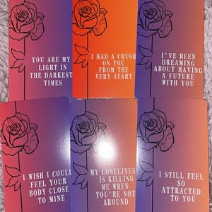 May include: Six rectangular cards with a purple, orange, and red gradient background. Each card has a rose illustration and a romantic phrase in white text, including "I had a crush on you from the very start" and "I still feel so attracted to you."
