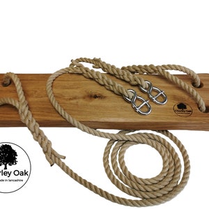 May include: A wooden swing set with natural rope and metal hooks. The swing is made of solid oak and has a natural finish. The rope is thick and durable, and the hooks are made of sturdy metal. The swing is perfect for adding a touch of rustic charm to any backyard.