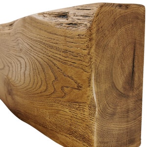 May include: A rustic, reclaimed wood beam with a natural, brown finish. The wood has a unique grain pattern and knots, giving it a characterful look.