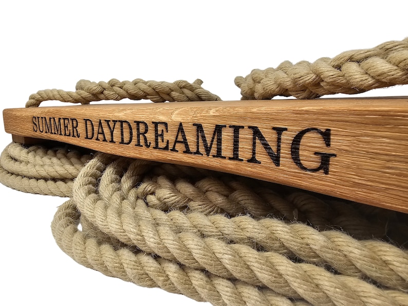 May include: A wooden swing set with thick rope and the words "SUMMER DAYDREAMING" engraved on the top.