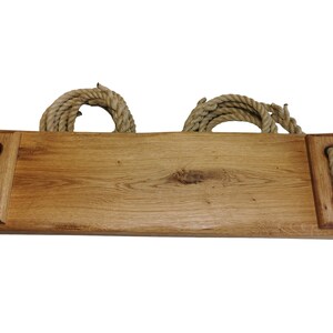 May include: A wooden swing set with rope handles. The swing is made of natural wood and has a rustic look.