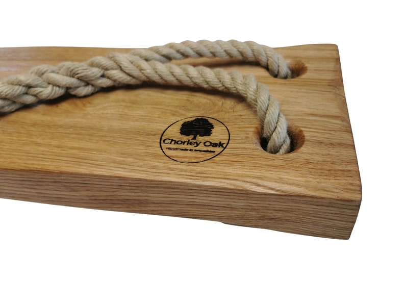 May include: A wooden swing seat with two rope loops and a logo that says "Chorley Oak Handmade in Lancashire".