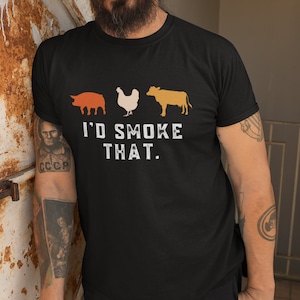 May include: Black t-shirt with a graphic of a pig, chicken, and cow with the text "I'd Smoke That."