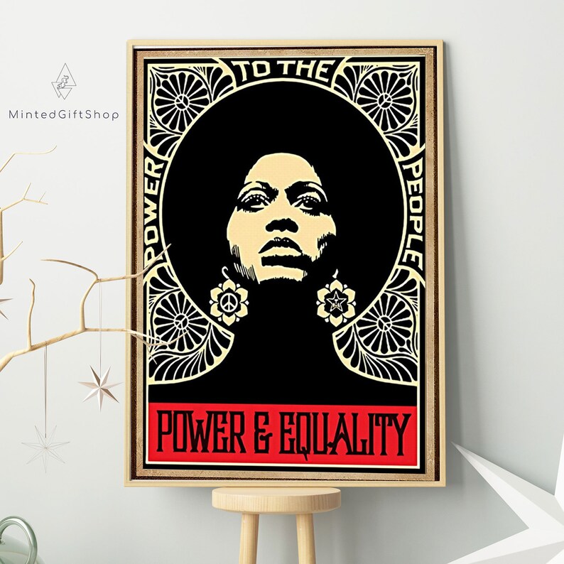 May include: A black and white poster featuring a woman with an afro wearing large earrings. The poster has a black background with a gold ornate border. The text on the poster reads "To The People" and "Power & Equality".