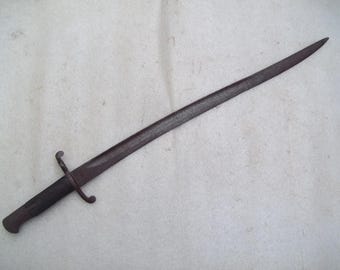 May include: A dark brown metal sword with a curved blade and a simple handle. The sword has a decorative guard with two loops.