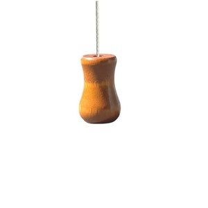 Könnte beinhalten: Ein Holz-Lichtschalter mit einer bauchigen Form und einer natürlichen Holzoptik.