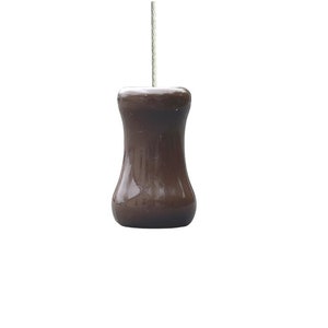 May include: A brown ceramic light pull with a simple design.
