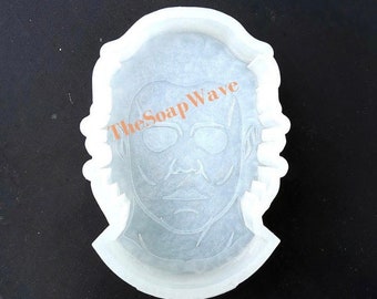May include: White silicone mold of a man's face with a mask. The mold is for making soap or other crafts. The text "TheSoapWave" is visible on the mold.