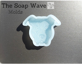 May include: A clear silicone mold shaped like a dog's head. The mold is designed to create soap or other crafts.