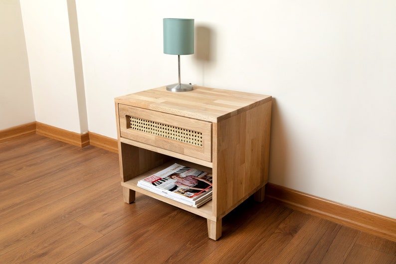 This Oak nightstand has a rattan framed drawer.