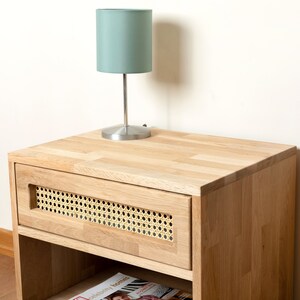 Night lamp and your books are sitting perfectly on the oak nightstand.