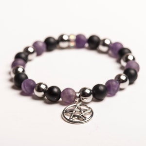May include: A black and purple beaded bracelet with a silver pentagram charm.