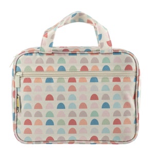 May include: A white toiletry bag with a zipper closure and a top handle. The bag has a colorful pattern of semi-circles in shades of pink, blue, green, and orange.