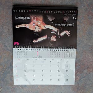 May include: A 2026 desk calendar featuring two table tennis players in action. The calendar shows the month of January with the date of the 1st highlighted. The calendar also shows the month of February with the date of the 2nd highlighted.