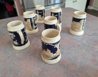 Made in West Germany Small Beer Stein Set of 7 Steins. Dark Blue.