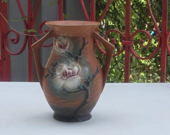 Vintage Roseville Double-Handled Magnolia Pattern 7" Vase featuring a prominent raised white floral motif Marked Roseville 90-7 on bottom