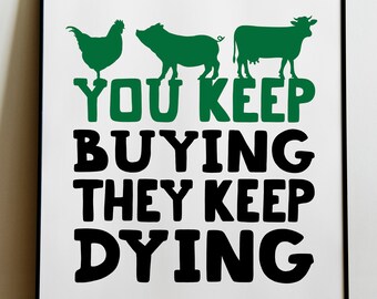 May include: Framed art print with a white background and black frame. The print features green silhouettes of a chicken, pig, and cow above the text "YOU KEEP BUYING THEY KEEP DYING" in green and black.