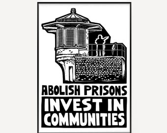 May include: A black and white print featuring a prison watchtower and two figures. The text "ABOLISH PRISONS INVEST IN COMMUNITIES" is displayed in bold, capital letters beneath the tower. The image is framed with a black border.
