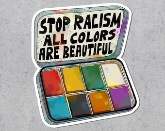 May include: A sticker showing a paint palette with the text "STOP RACISM ALL COLORS ARE BEAUTIFUL." The palette has eight rectangular paint colours: red, yellow, green, white, blue, brown, purple, and orange.