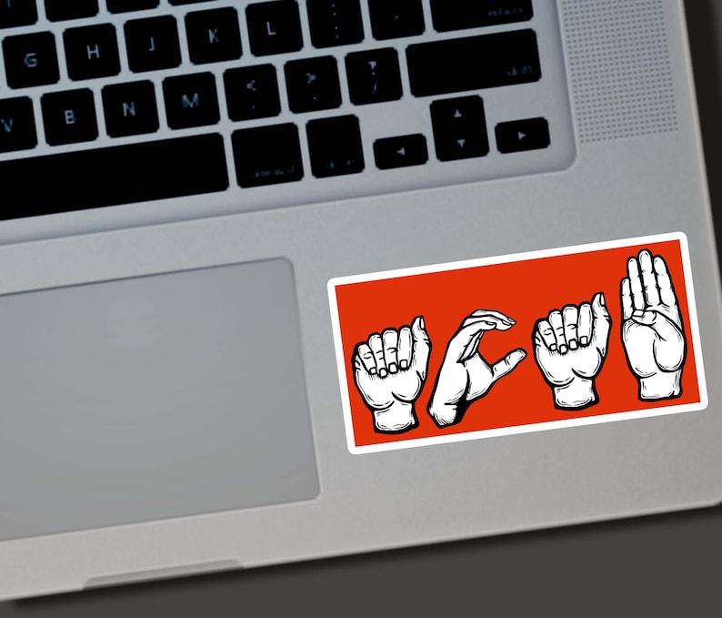May include: A rectangular sticker with the word "HOPE" spelled out in American Sign Language, featuring white hand illustrations on a bright orange background. The sticker is placed on a laptop.